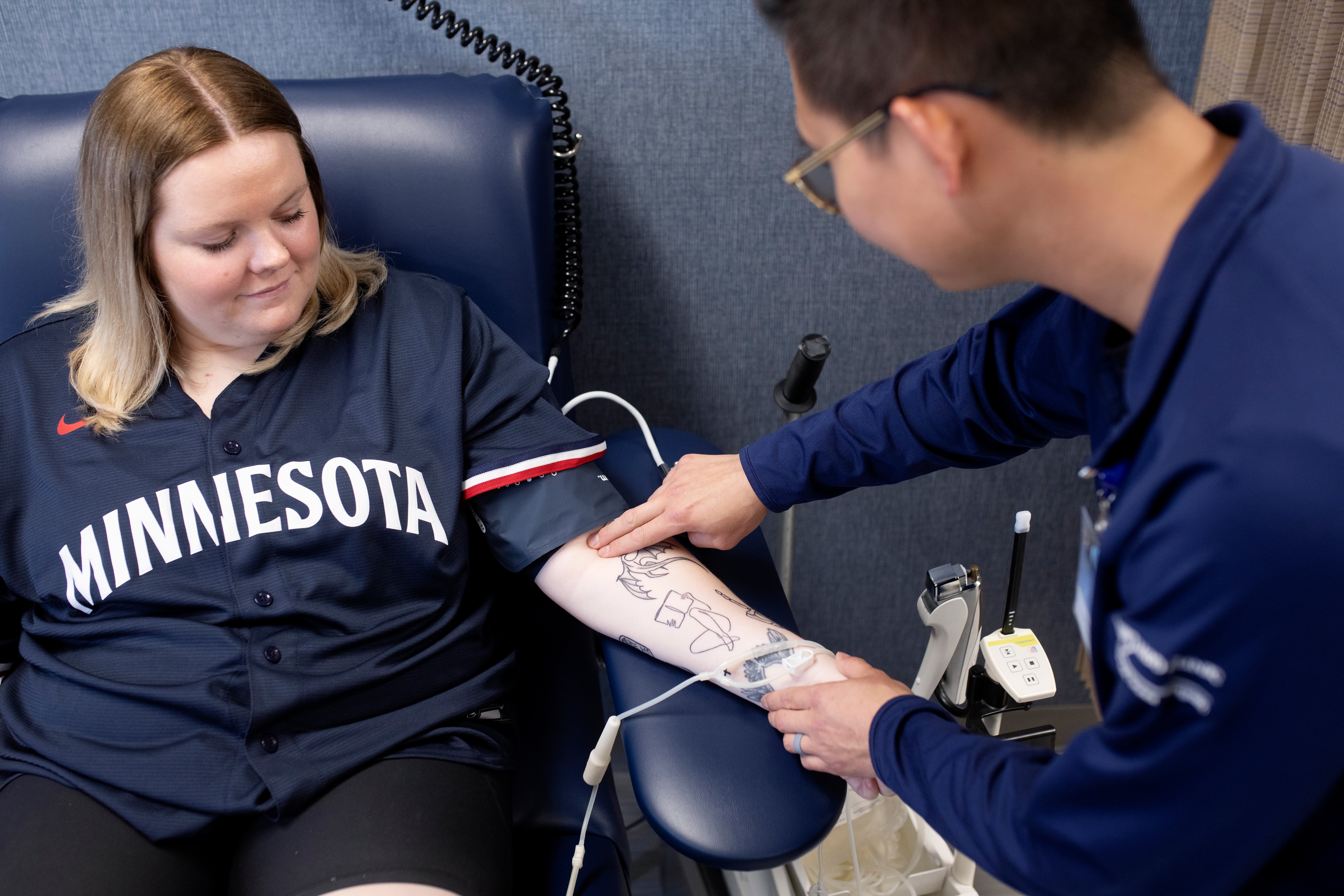 Healthcare professional feels for a vein in the arm of a person who is about to donate blood.